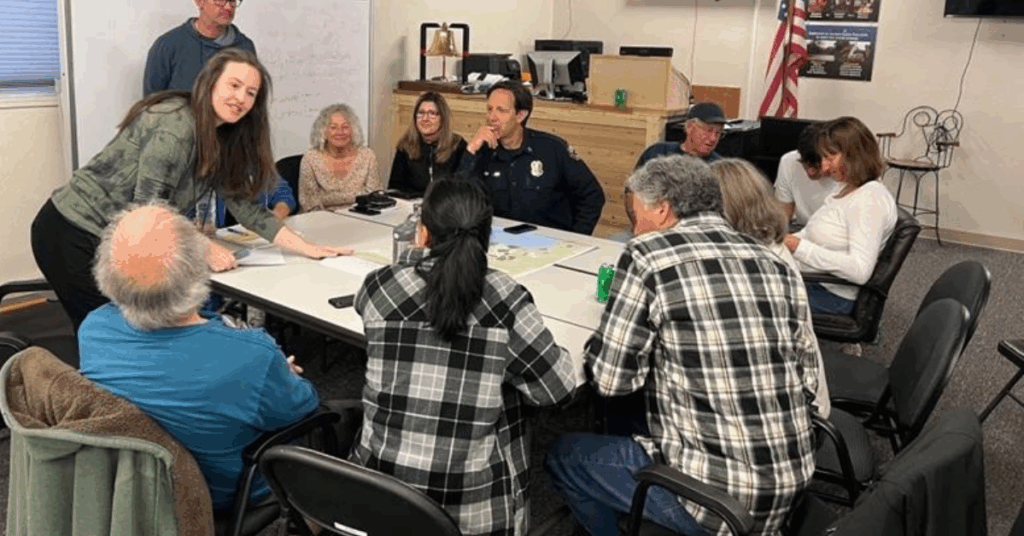 CWPP Webpage Header Photo of a group of people gathered around a table talking and looking at the papers on the table.